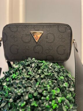 GUESS Black Logo-Patterned Crossbody Bag with Gold Triangle Emblem